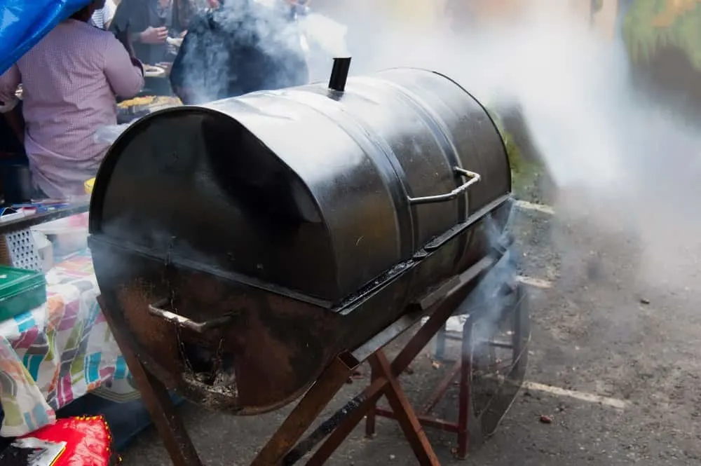 A barbecue made from a 55 gallon metal barrel