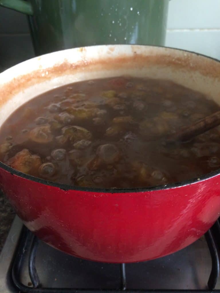 Boiling preserves in an enamel cast iron Dutch oven.