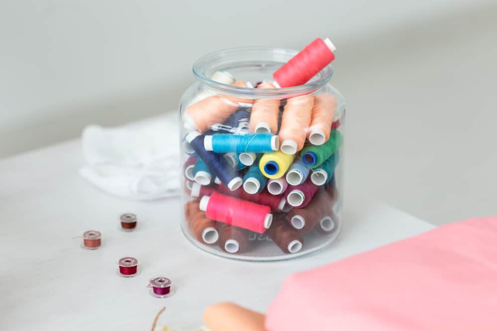 Sewing kit in a glass jar