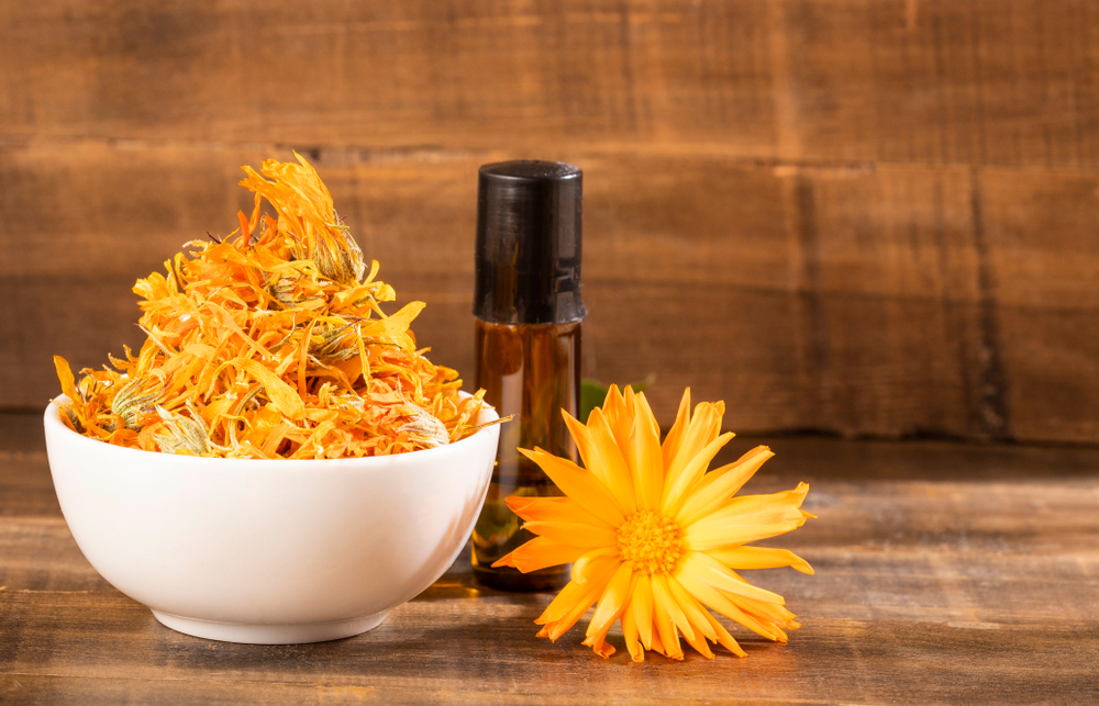 Calendula in bowl and bottle behind