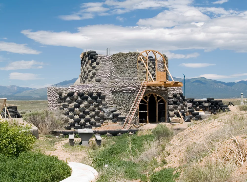 Earthship home with tires in walls