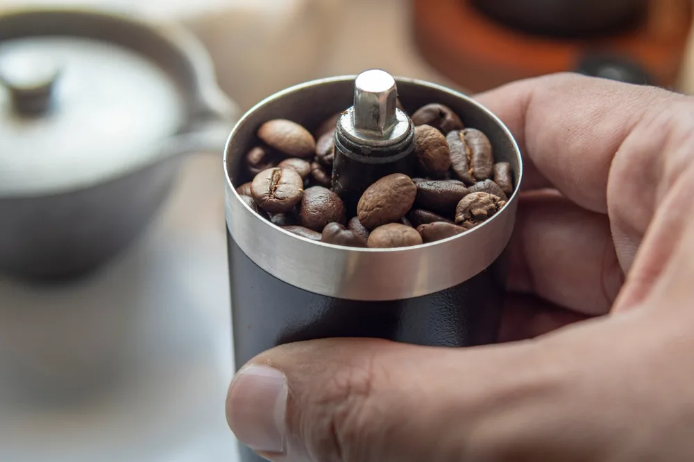 Coffee beans in a manual coffee grinder