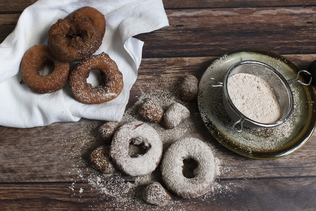 Homemade donuts sprinkled with cinnamon and sugar.