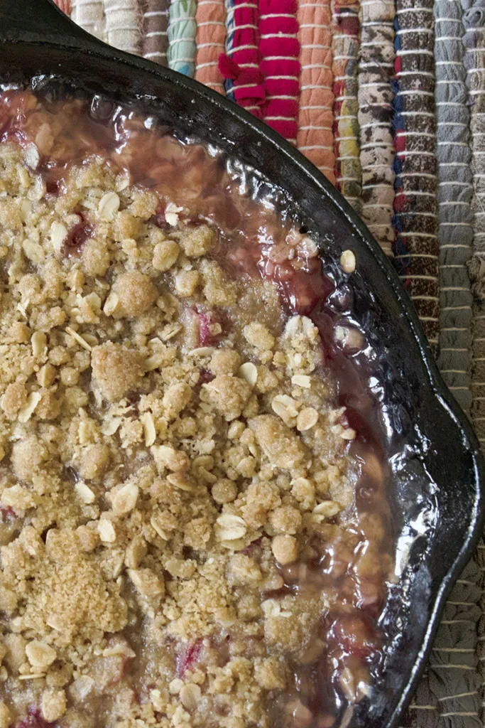 A cast iron skillet with rhubarb crisp in it