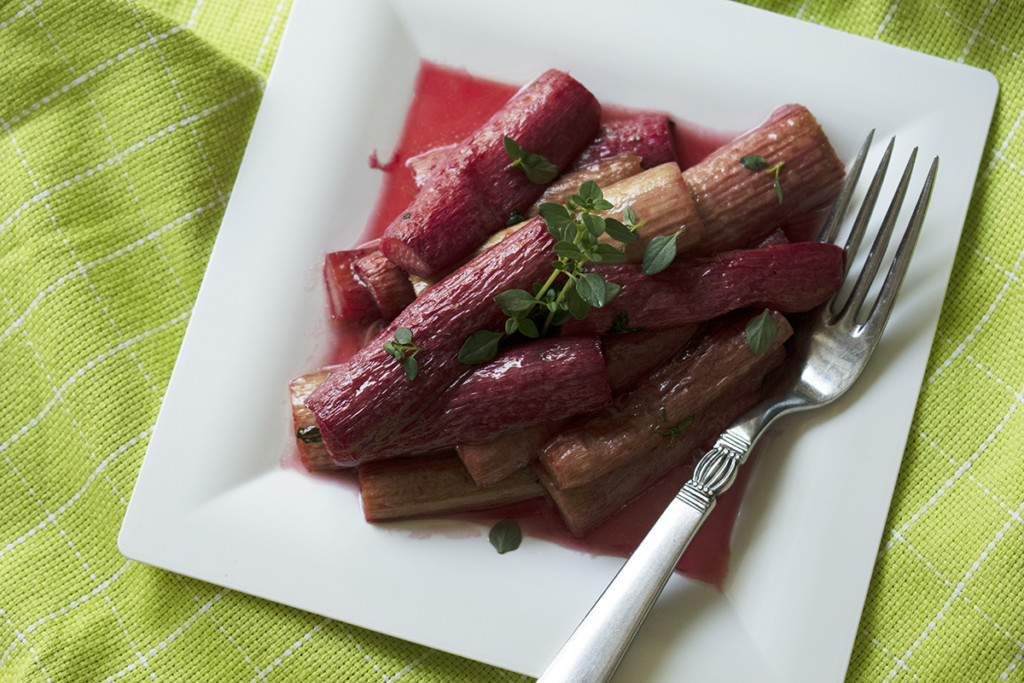 Roasted rhubarb on a plate with a fork.