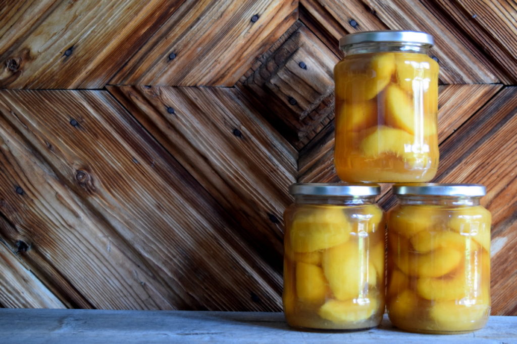 Three jars of canned peaches.
