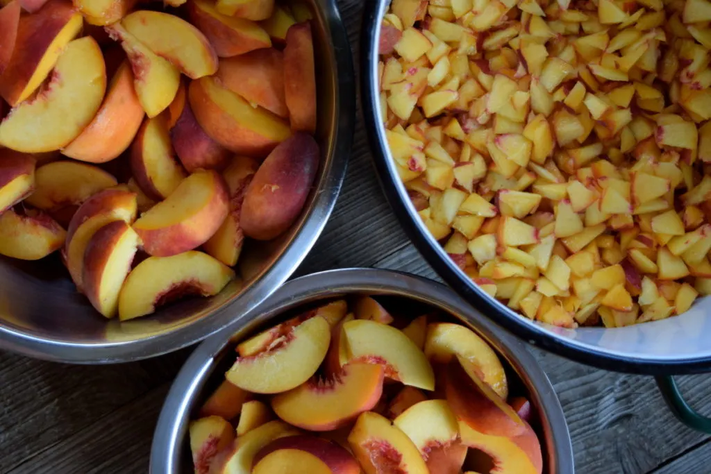 Bowls of cut and chopped peaches. 