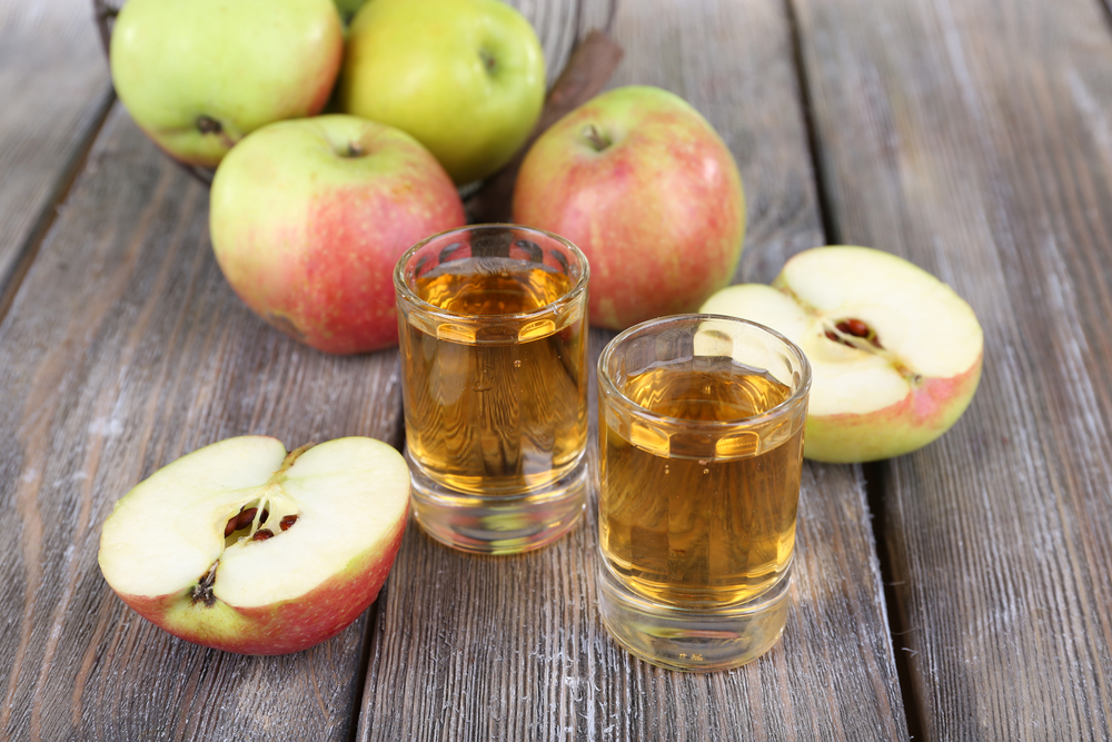 Preserving apples by making apple-infused brandy.