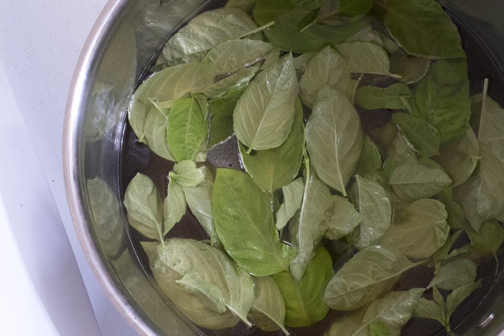 A pot of water with honey and basil leaves added to it