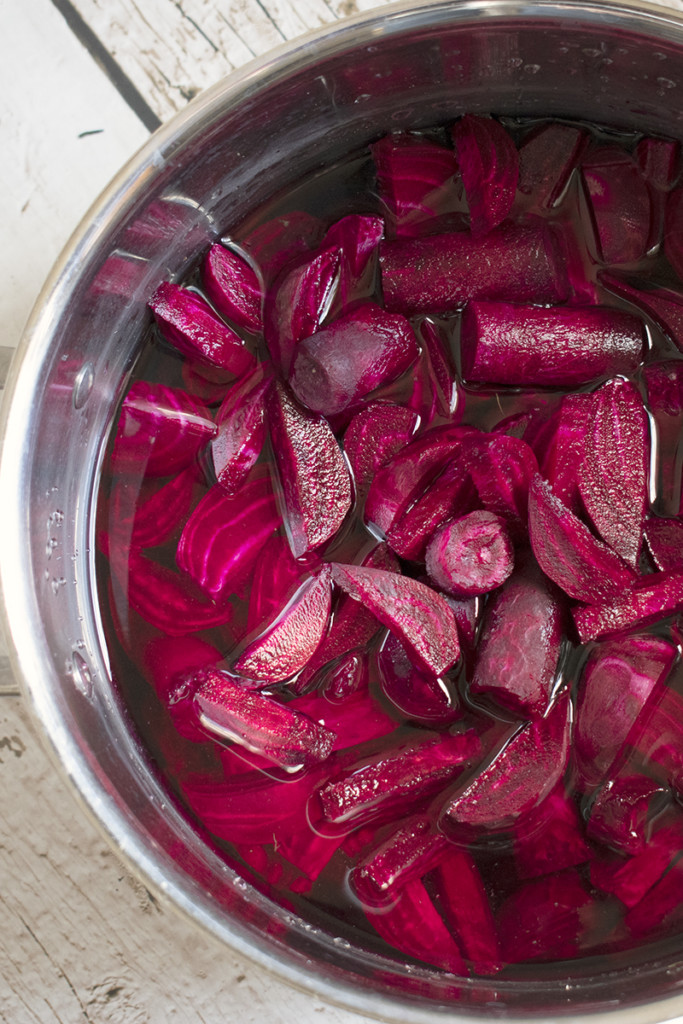 A stockpot full of beets and water.