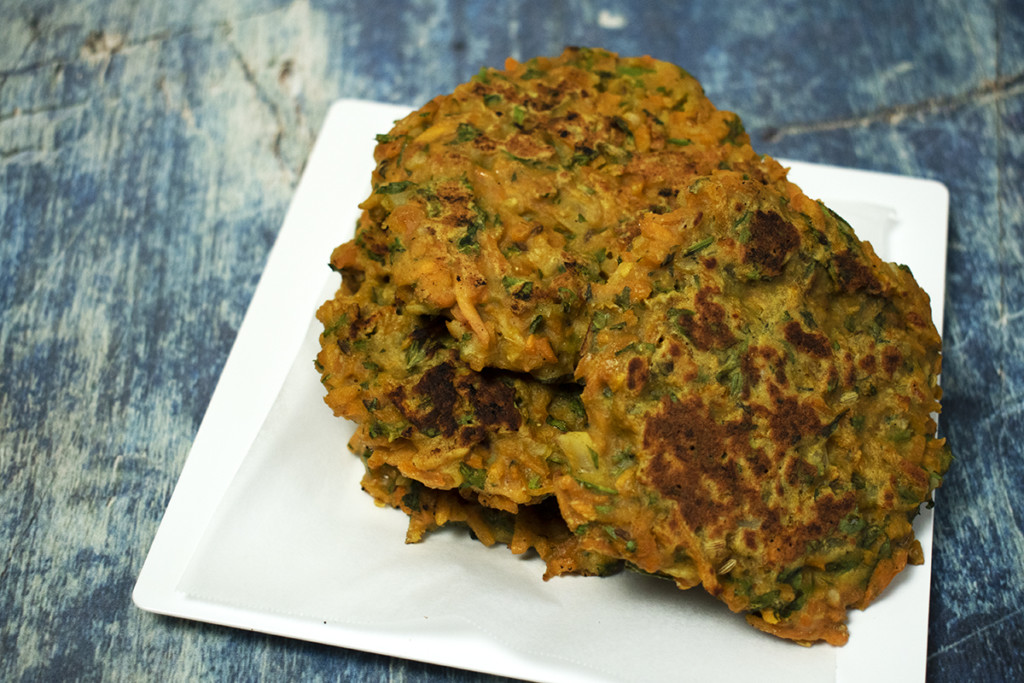 Carrot top fritters on a white plate.