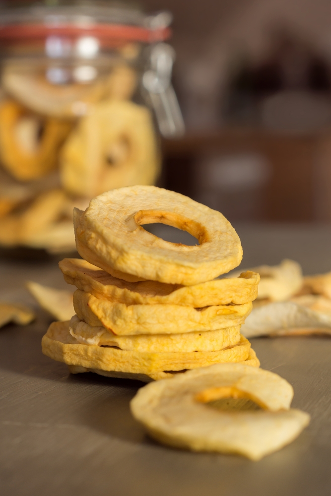 Dehydrated apple slices stacked.