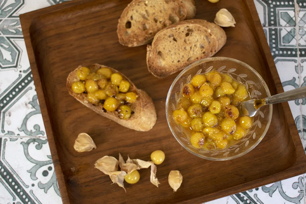 Blistered ground cherries served on toasted baguette slices