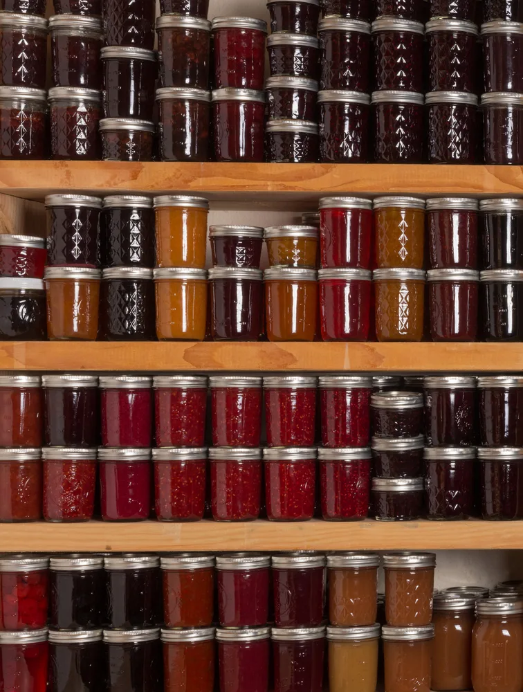 Shelves filled with all different kinds of jams and jellies.