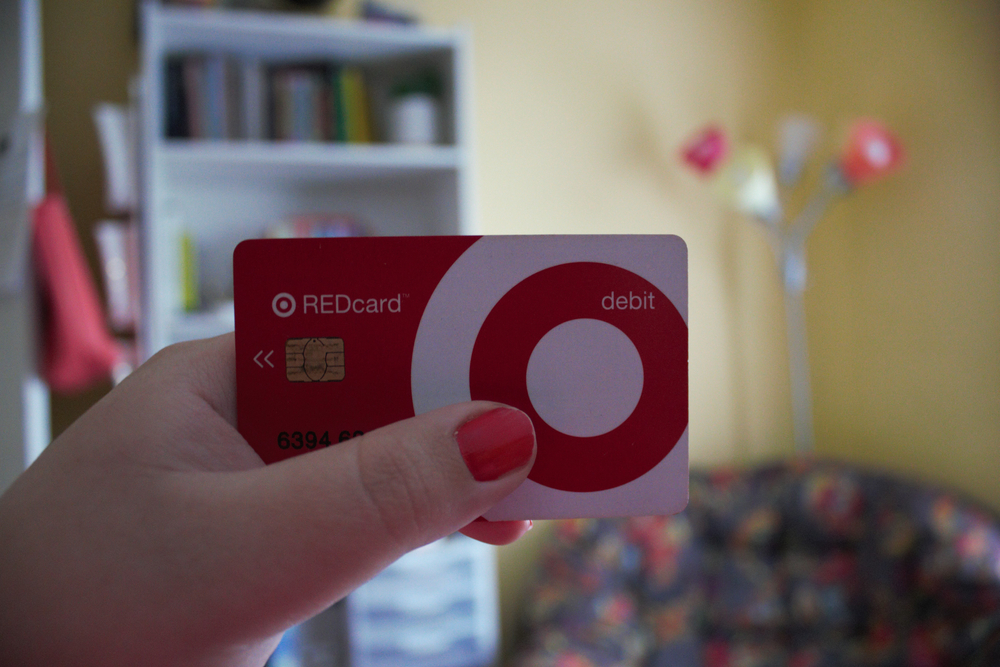 A hand holding up a Target REDcard.