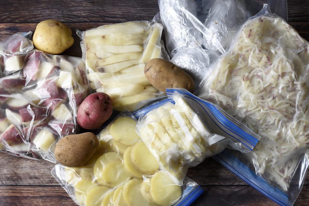 Assorted freezer bags filled with frozen potatoes.