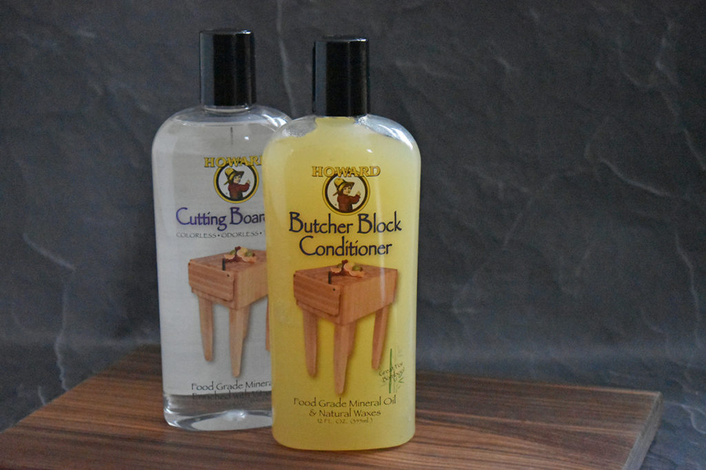 Howard wood care butcher block conditioner and cutting board oil are pictured.