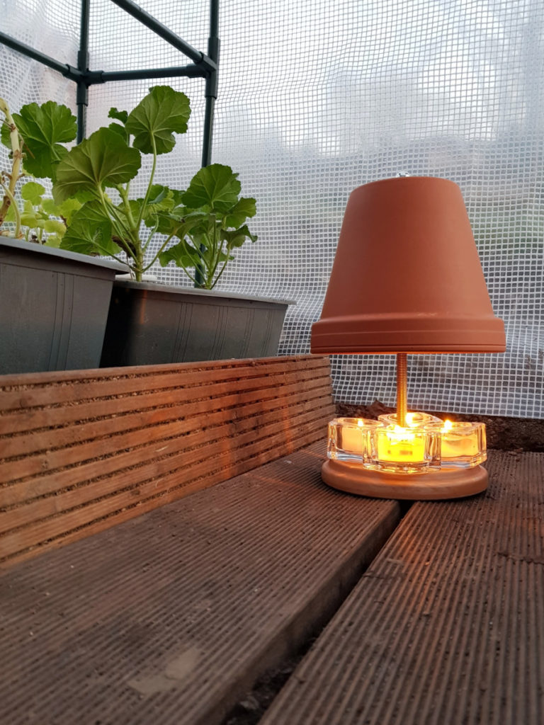 Simple heater made from a terracotta planter with tealight candles beneath it. 