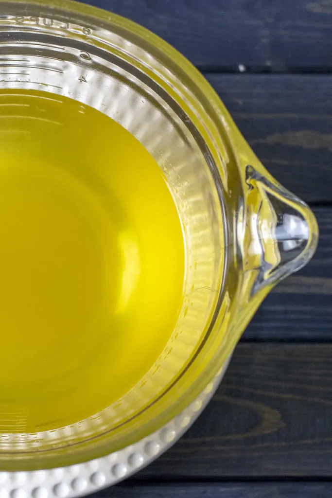 A close up of a bowl of lemon-infused vodka.