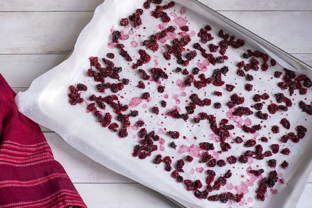 The same baking sheet with cranberries after they have been dried overnight in the oven.