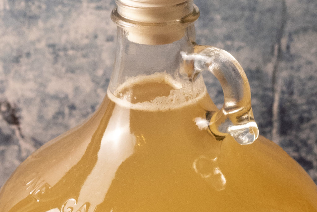 Close up of the next of the gallon jug with the mead in it.