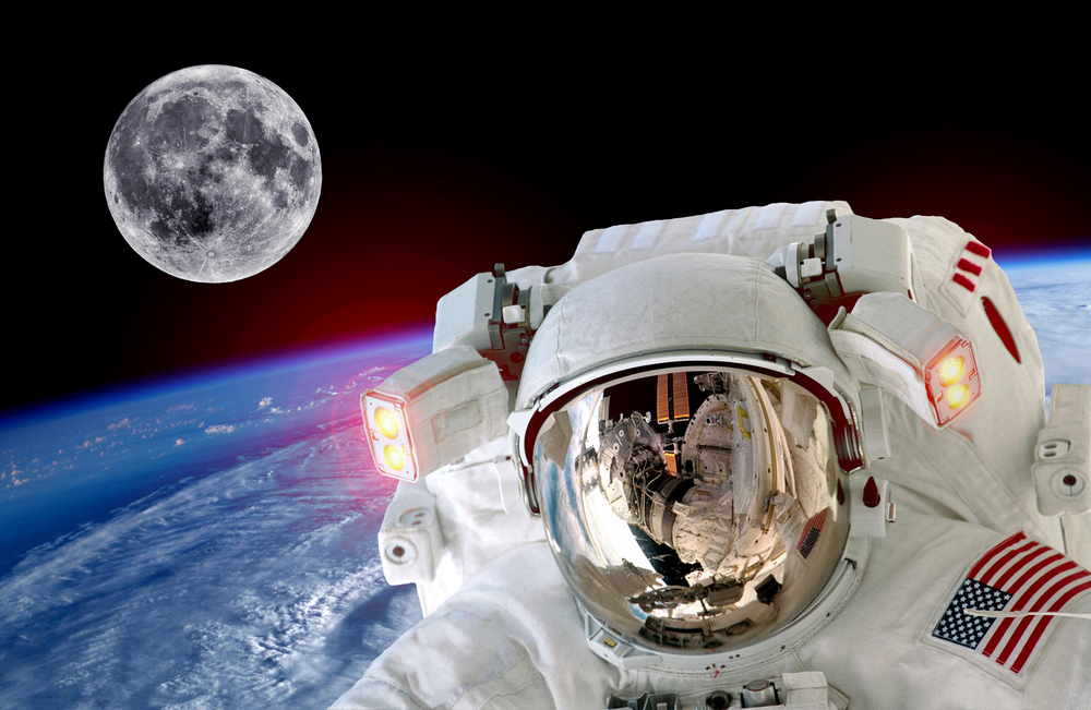 Image of an astronaut in space with the earth and moon behind them.
