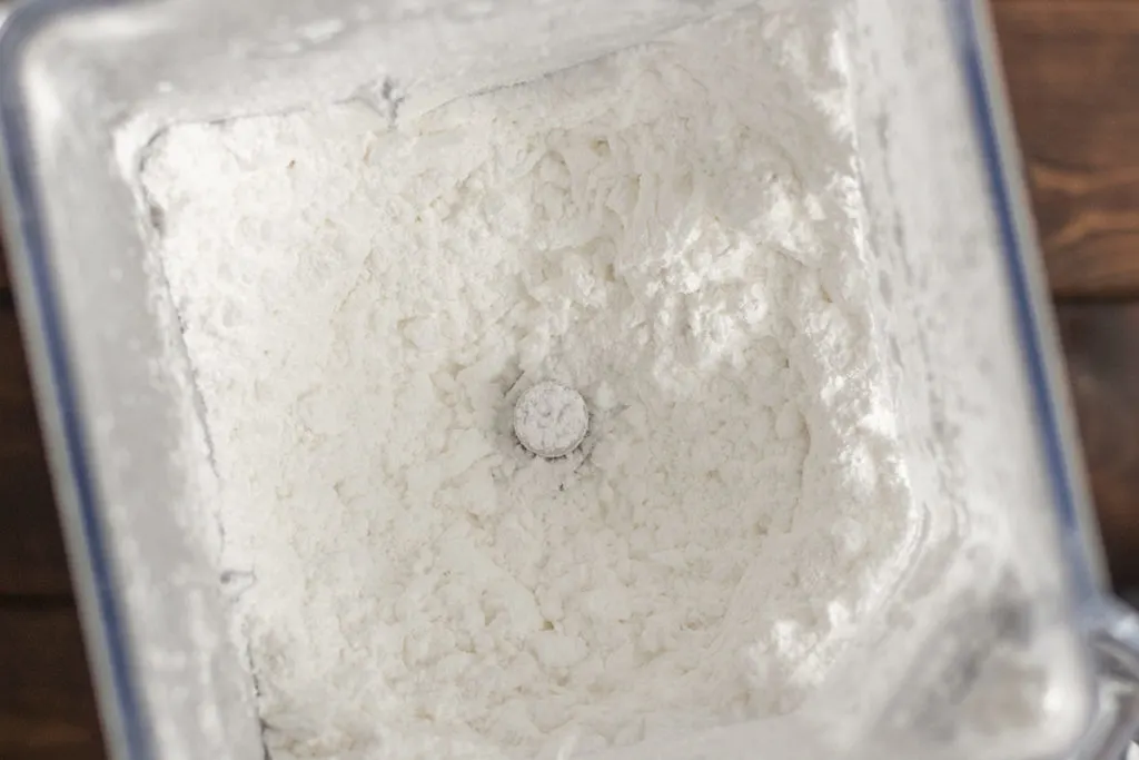 Close up of homemade powdered sugar in blender jar.