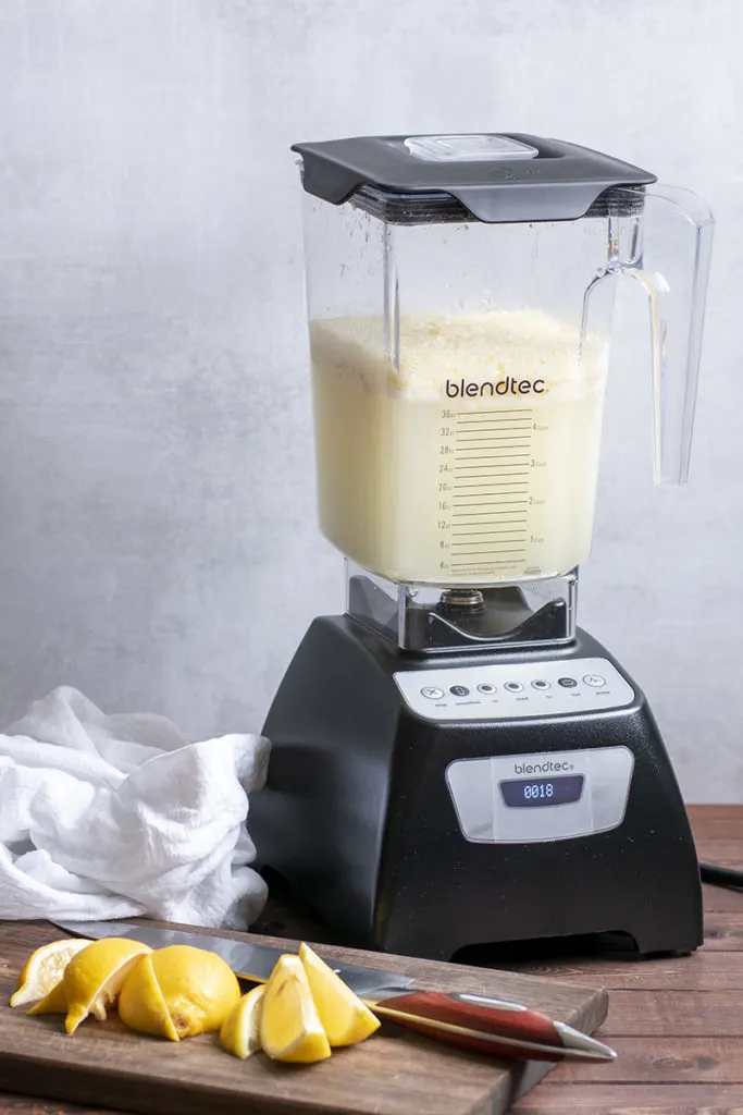 A blender with blended lemonade in it. 