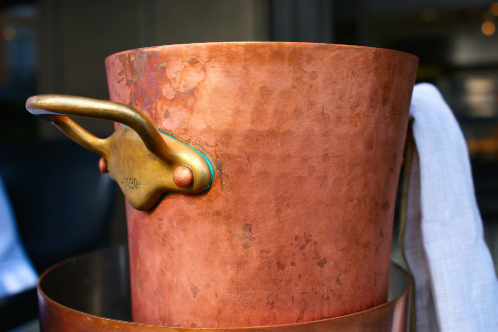 A large unlacquered copper pot.
