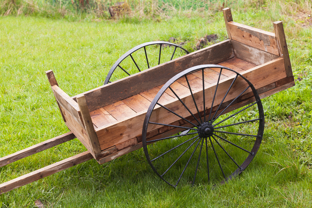 A rustic garden cart made of wood pallet pieces.