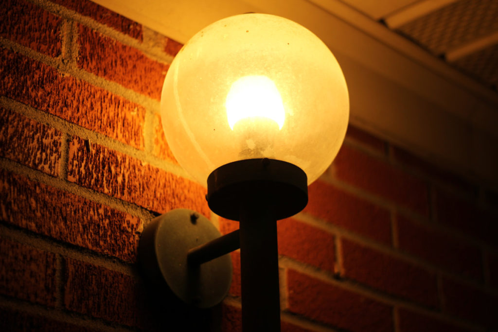 A globe-shaped porch light is lit up.