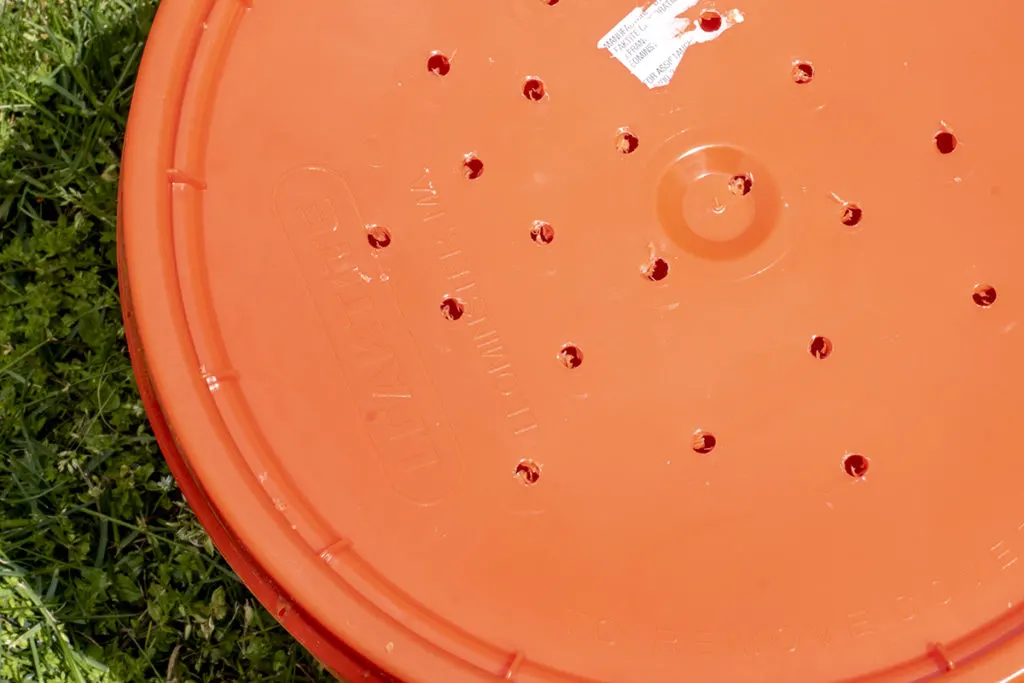 Close up of lid drilled with holes.