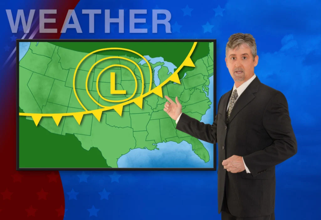 a weatherman points to a weather map of the United States. 