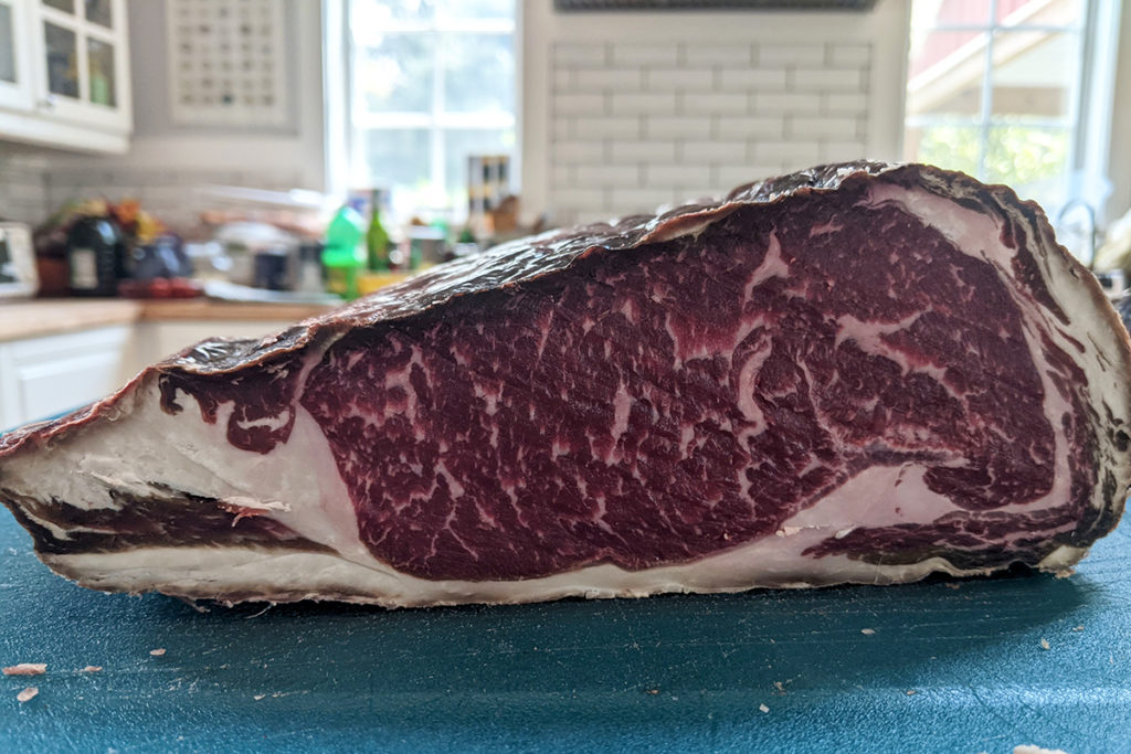 Sideview of a whole ribeye that has been dry-aged. 