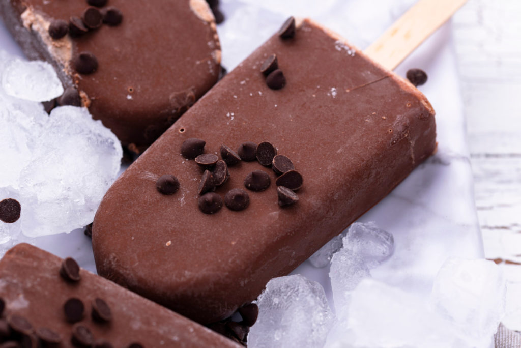 Chocolate pudding popsicles sprinkled with mini chocolate chips