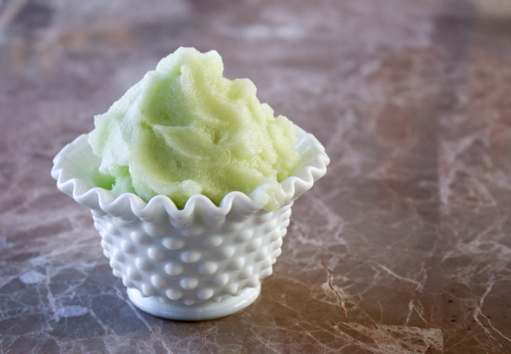 A small dish of pale green cucumber sorbet