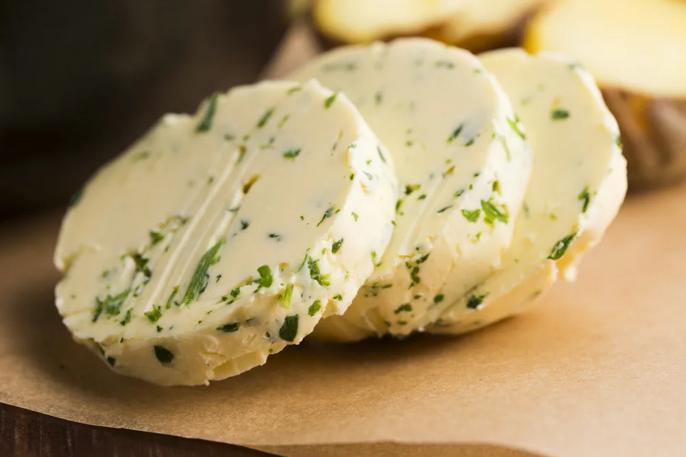 Sliced rounds of chive butter.