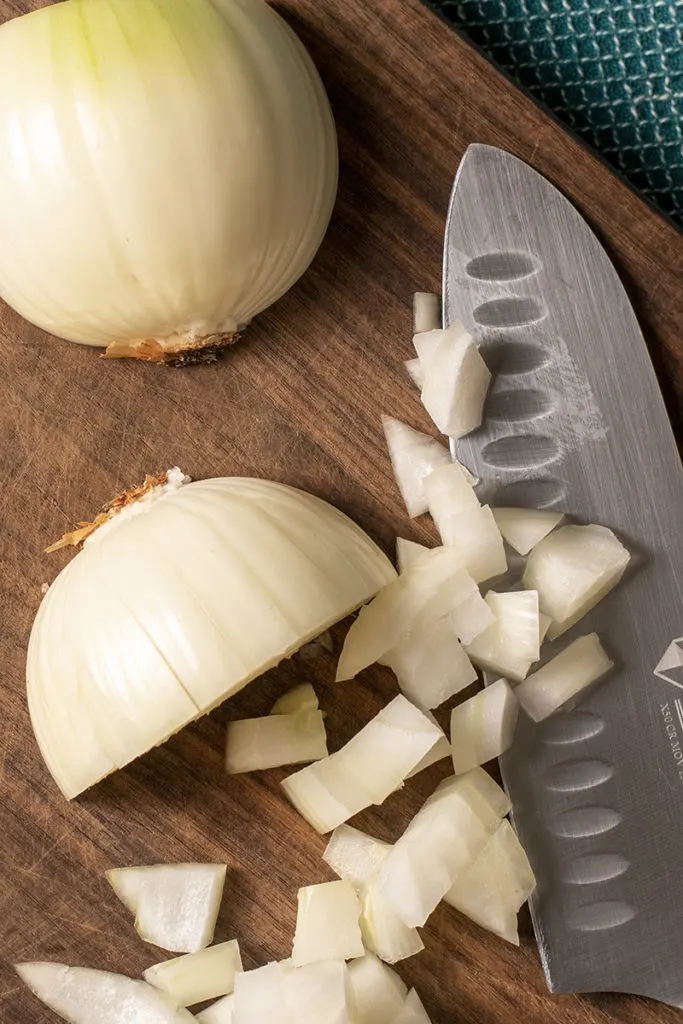 Close up of an onion that's being diced. 