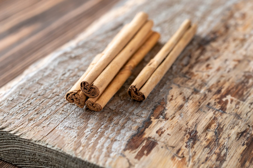 Cinnamon sticks on a roughhewn piece of wood
