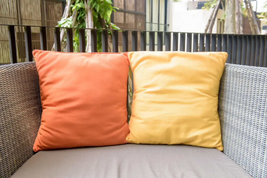 Two outdoor pillows on a chair.