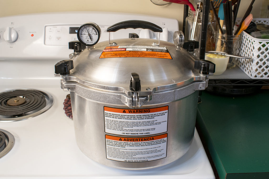 All American pressure canner on stovetop.