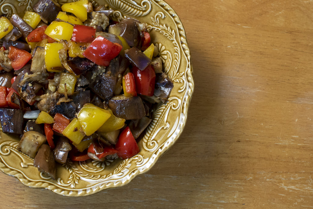 A serving bowl with the cooked eggplant and peppers. 