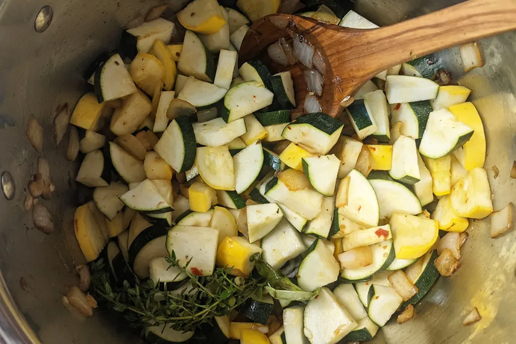 Overhead view of stockpot, I have added the cubed summer squash to the onions.