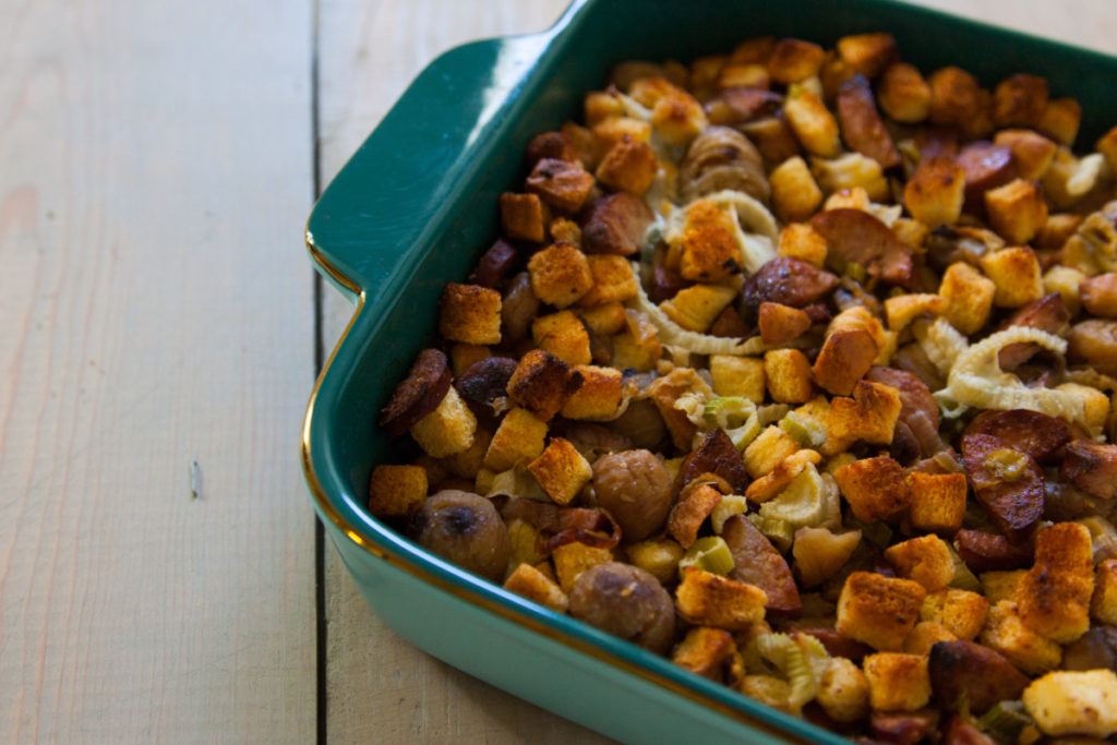 A teal casserole dish of chestnut stuffing