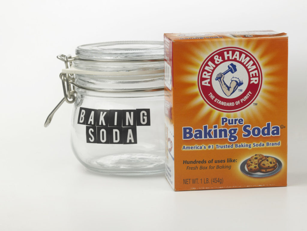 empty jar labeled "baking soda" next to a box of arm & hammer baking soda