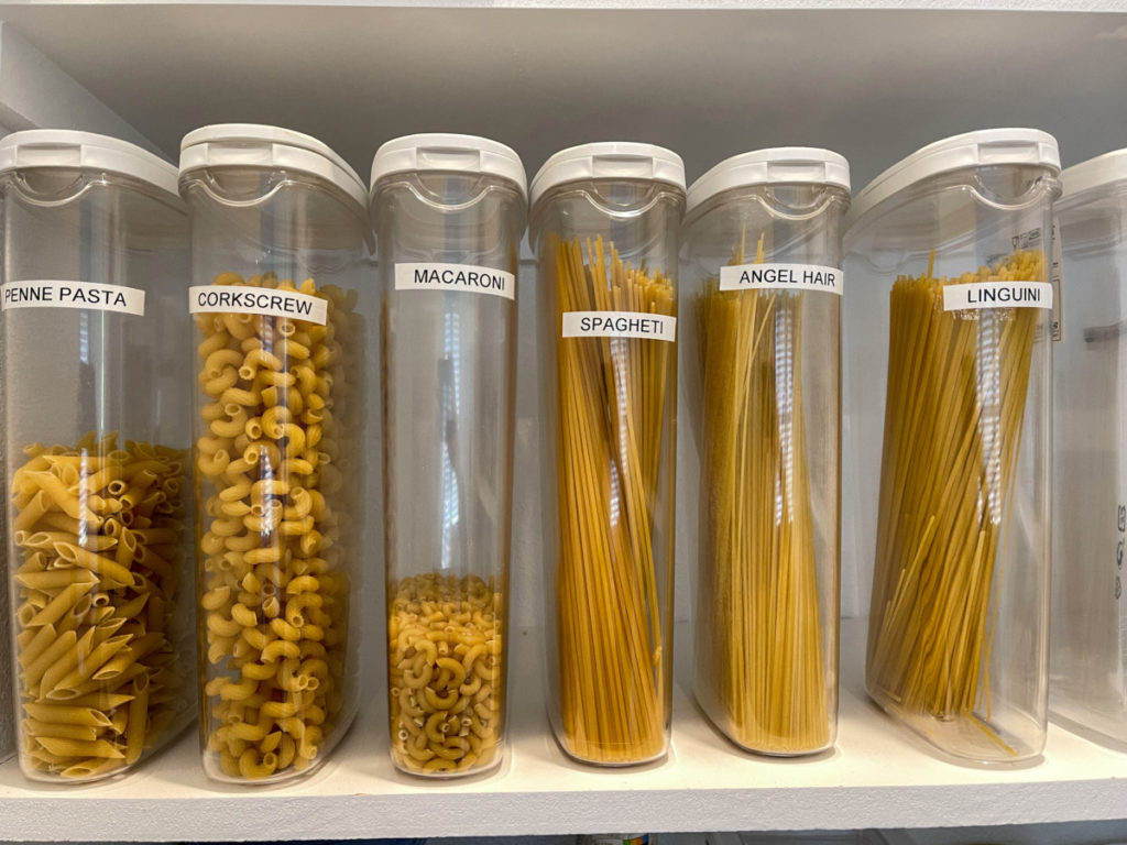 Tall pasta storage containers filled with pasta