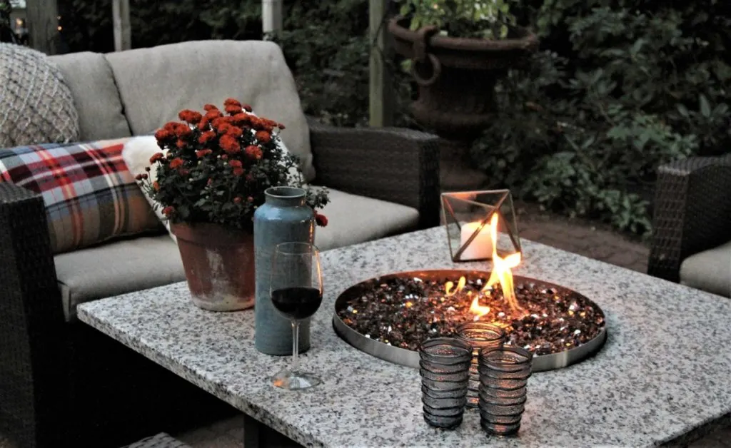a gas fire pit inlaid into a marble table top.