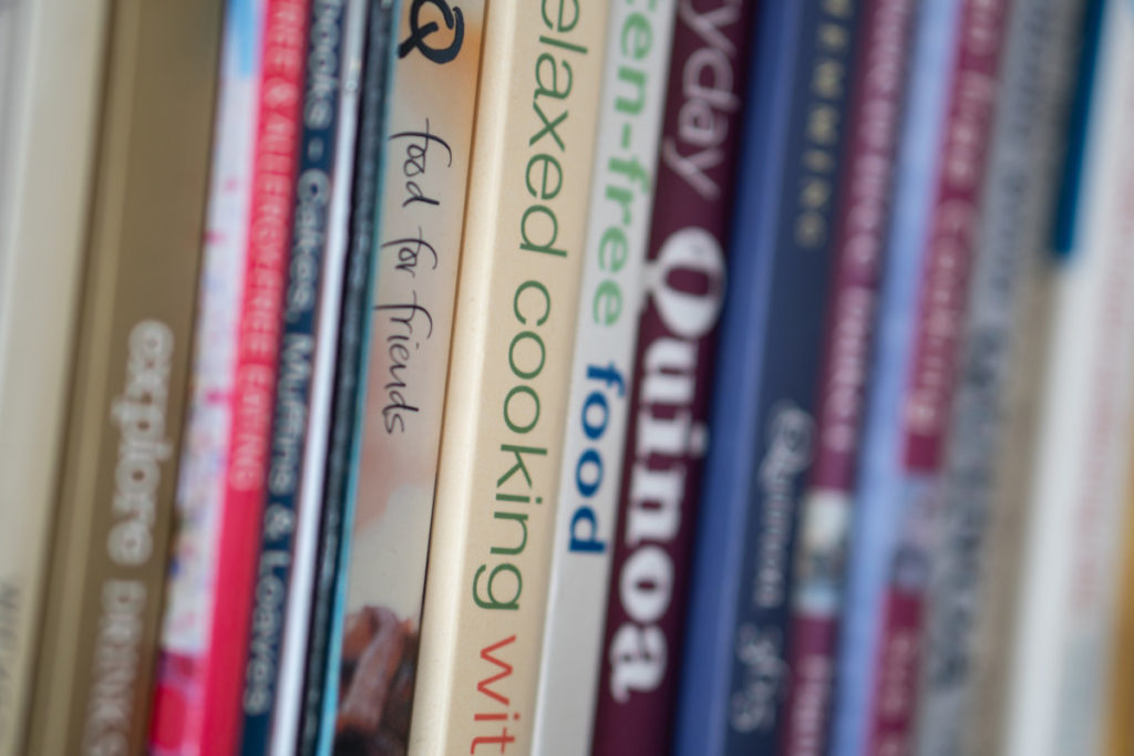 A row of cookbooks with blurry titles.