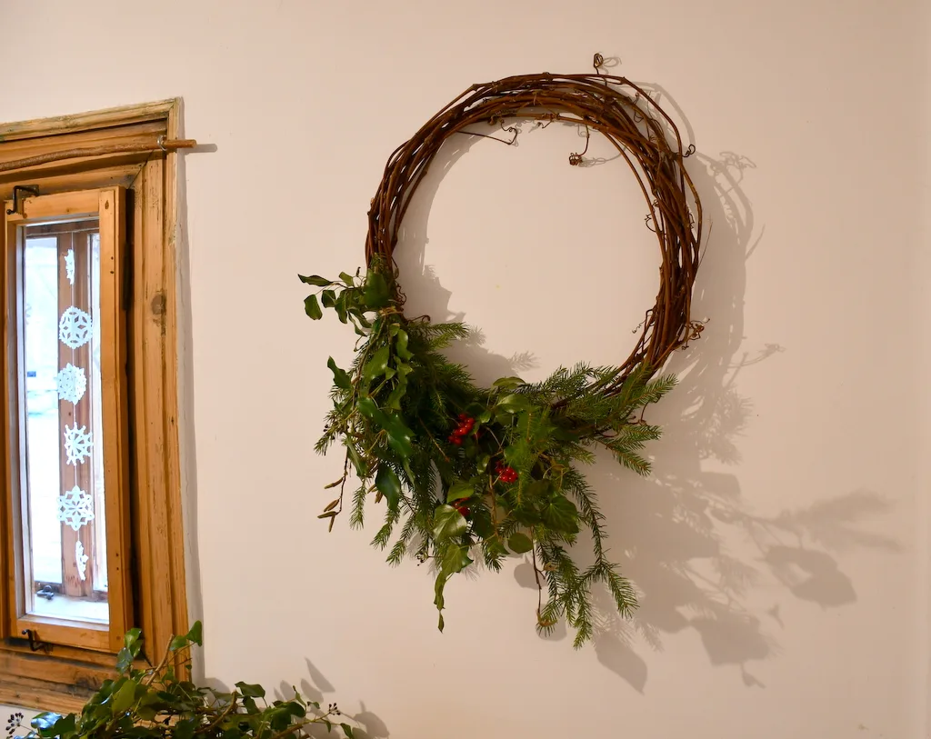 Wreath partially made hung on the wall to view the progress