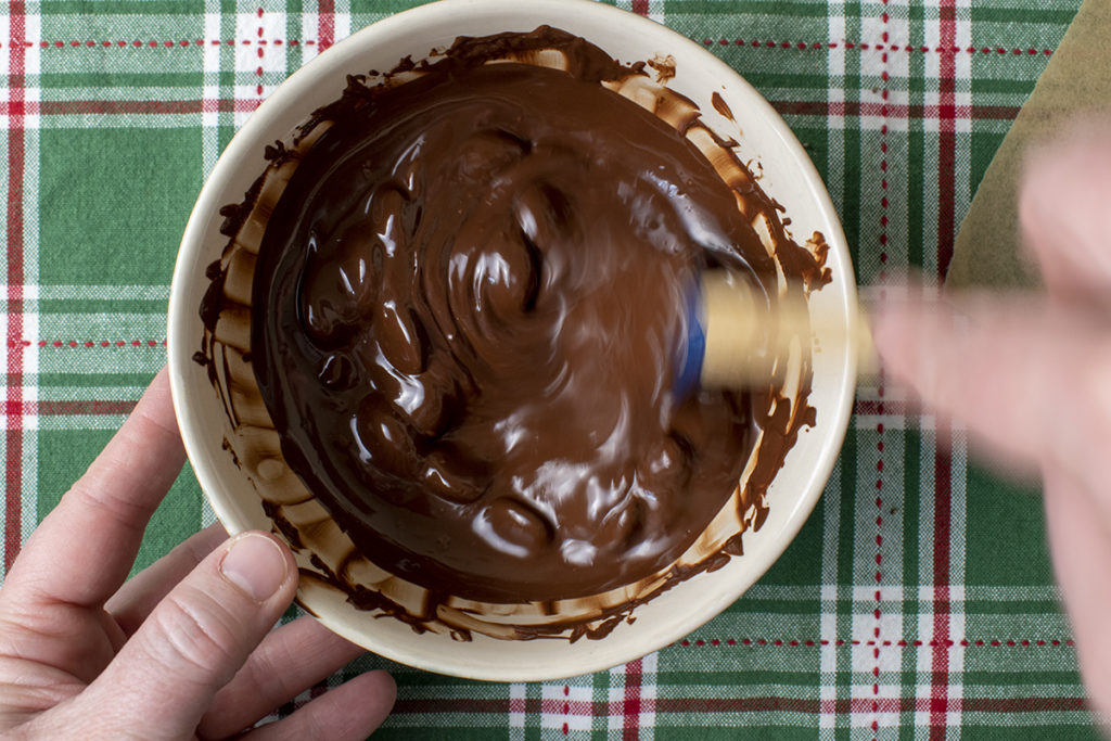 stirring chocolate as it melts